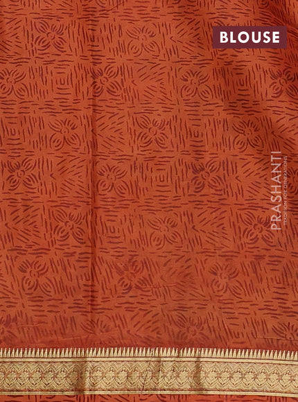 Pure printed silk saree orange with allover prints and madhubani printed zari woven border