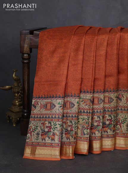Pure printed silk saree orange with allover prints and madhubani printed zari woven border
