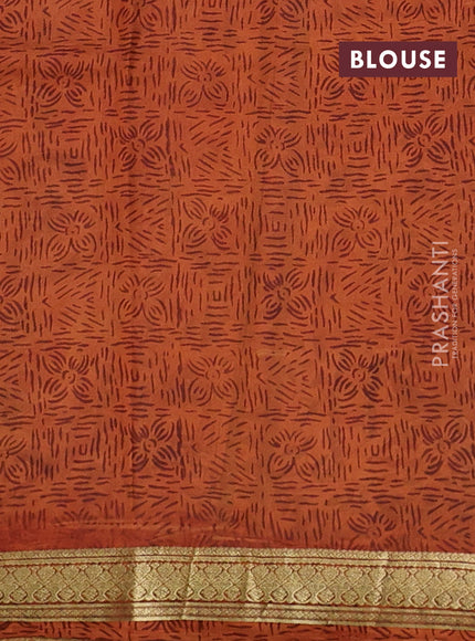 Pure printed silk saree orange with allover prints and madhubani printed zari woven border