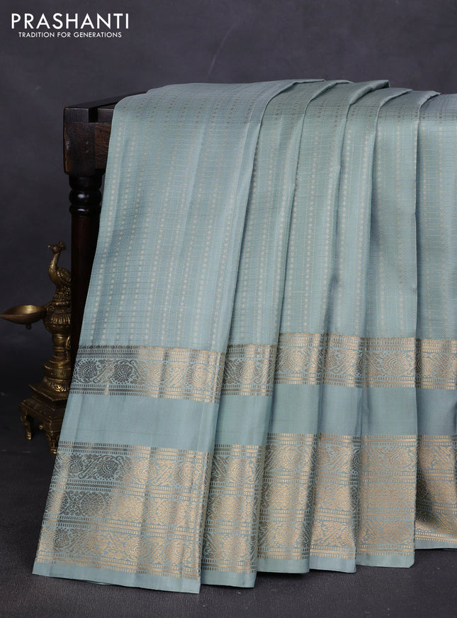 Pure kanchipuram silk saree pastel green shade with allover small zari checks & buttas and long rettapet zari woven border
