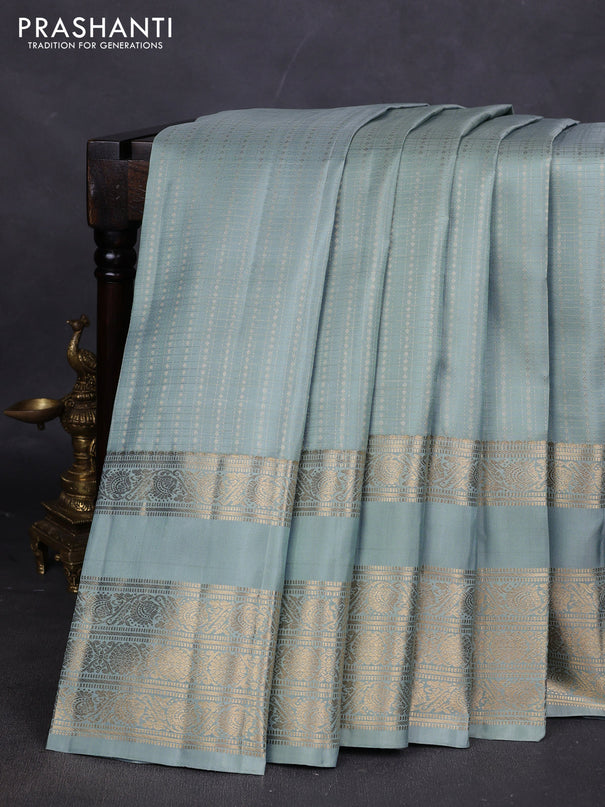 Pure kanchipuram silk saree pastel green shade with allover small zari checks & buttas and long rettapet zari woven border