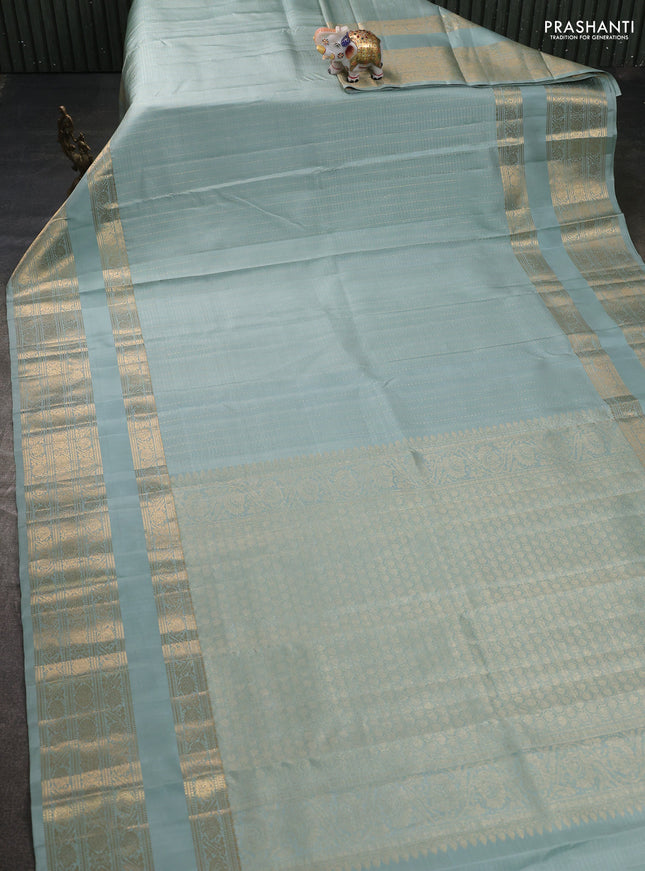 Pure kanchipuram silk saree pastel green shade with allover small zari checks & buttas and long rettapet zari woven border