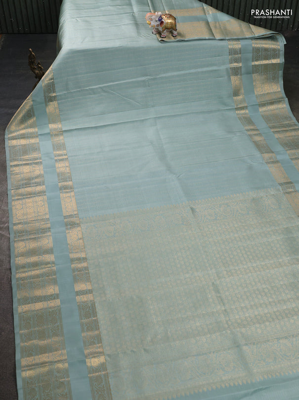 Pure kanchipuram silk saree pastel green shade with allover small zari checks & buttas and long rettapet zari woven border