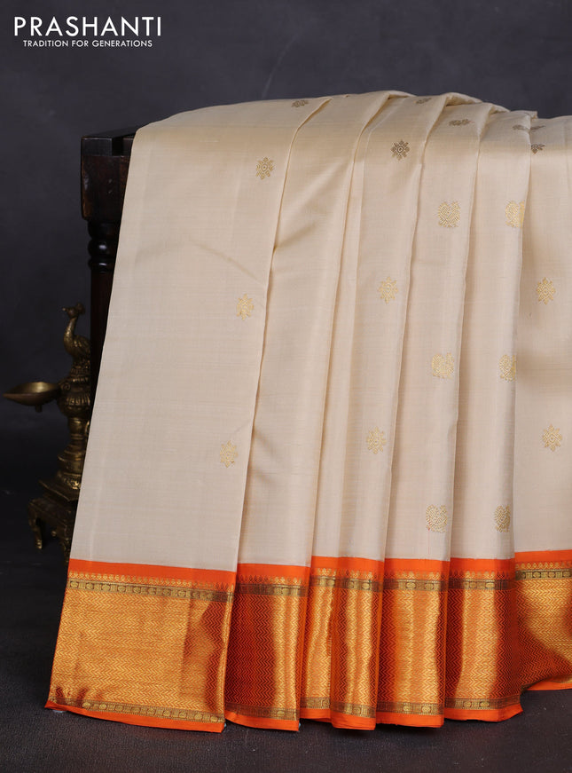 Pure kanchipuram silk saree cream and orange with zari woven buttas and rich zari woven border