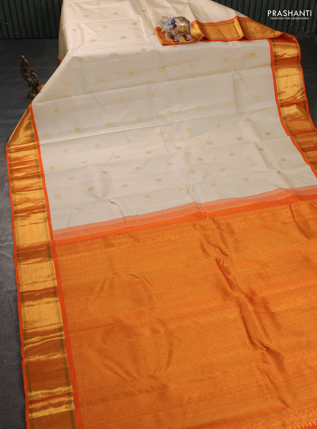 Pure kanchipuram silk saree cream and orange with zari woven buttas and rich zari woven border