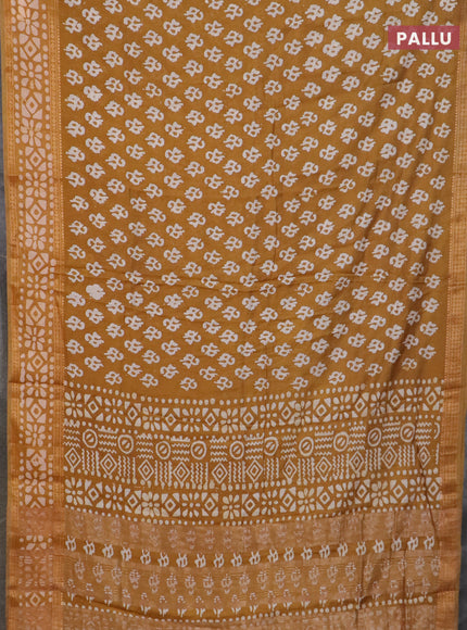 Semi maheswari cotton saree dark mustard with allover batik prints and rettapet printed border