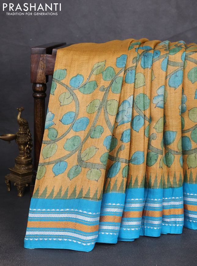 Pure tussar silk saree mustard shade and cs blue with allover kalamkari hand painted prints and temple design virdharbha border