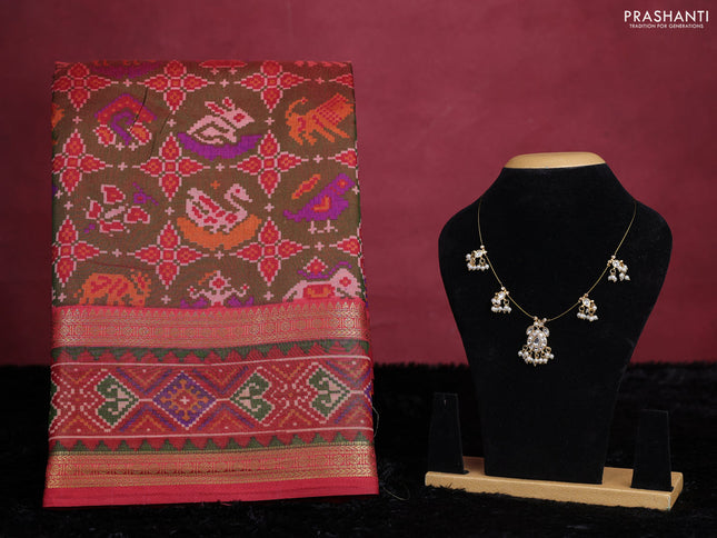 Manthulir green semi tussar saree with matching Neck piece