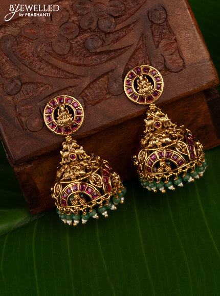 Antique jhumka lakshmi design with pink kemp stones and green beads hanging