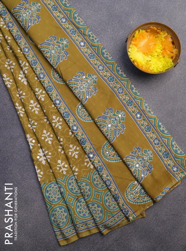 Muslin silk saree mehendi green and teal green with allover dabu prints & pita work and ajrakh printed border