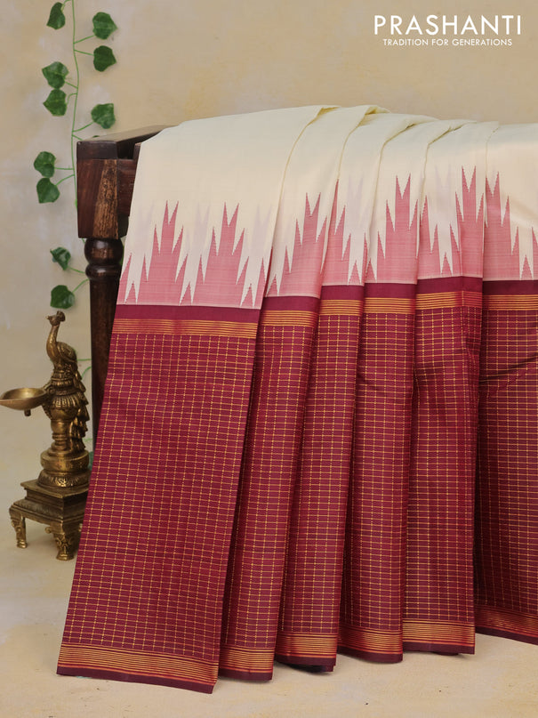 Pure kanchipuram silk saree cream and deep maroon with plain body and long temple design zari checked border