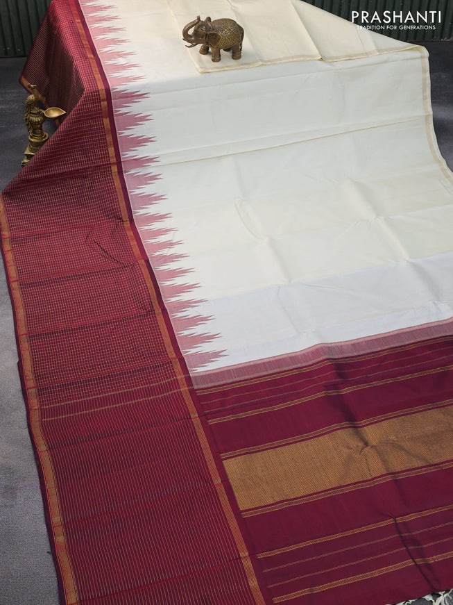 Pure kanchipuram silk saree cream and deep maroon with plain body and long temple design zari checked border