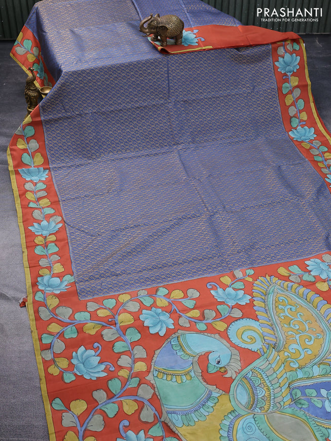 Pure kanchipuram silk saree blue shade and rustic orange with allover zari woven brocade weaves and kalamkari printed pallu & border