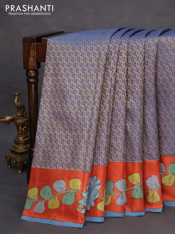 Pure kanchipuram silk saree blue shade and rustic orange with allover zari woven paisley brocade weaves and kalamkari printed pallu & border