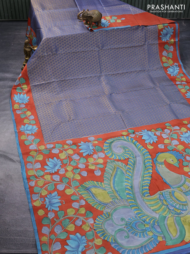 Pure kanchipuram silk saree blue shade and rustic orange with allover zari woven paisley brocade weaves and kalamkari printed pallu & border