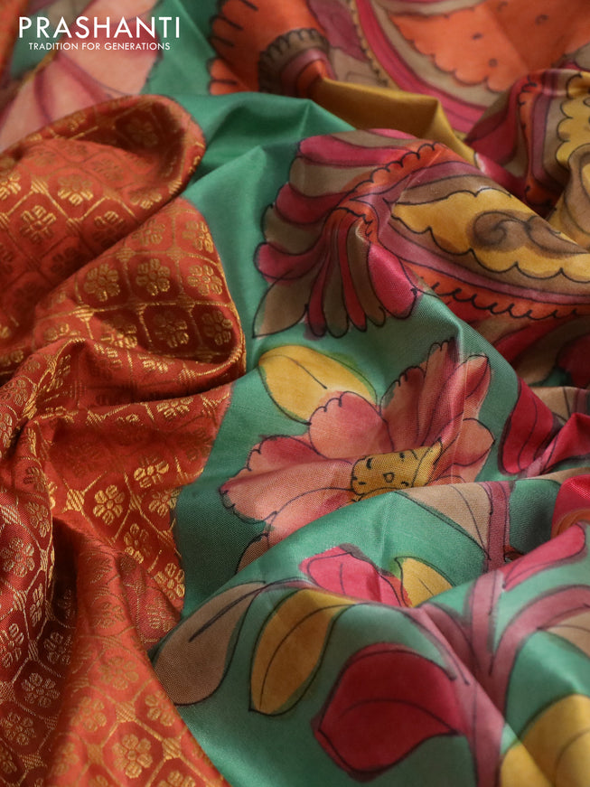 Pure kanchipuram silk saree rust shade and teal green with allover zari woven brocade weaves and kalamkari printed pallu & border