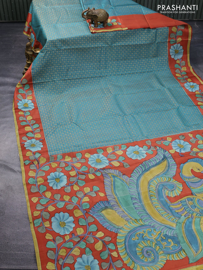 Pure kanchipuram silk saree teal blue shade and rustic orange with allover zari woven brocade weaves and kalamkari printed pallu & border