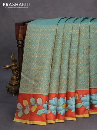 Pure kanchipuram silk saree teal green shade and rustic orange with allover zari woven geometric brocade weaves and kalamkari printed pallu & border