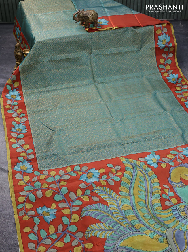 Pure kanchipuram silk saree teal green shade and rustic orange with allover zari woven geometric brocade weaves and kalamkari printed pallu & border