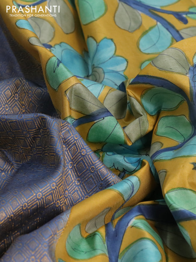 Pure kanchipuram silk saree blue shade and mustard yellow with allover zari woven geometric brocade weaves and kalamkari printed pallu & border