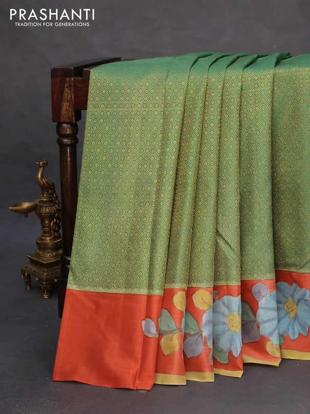 Pure kanchipuram silk saree teal green and rustic orange with allover zari woven geometric brocade weaves and kalamkari printed pallu & border