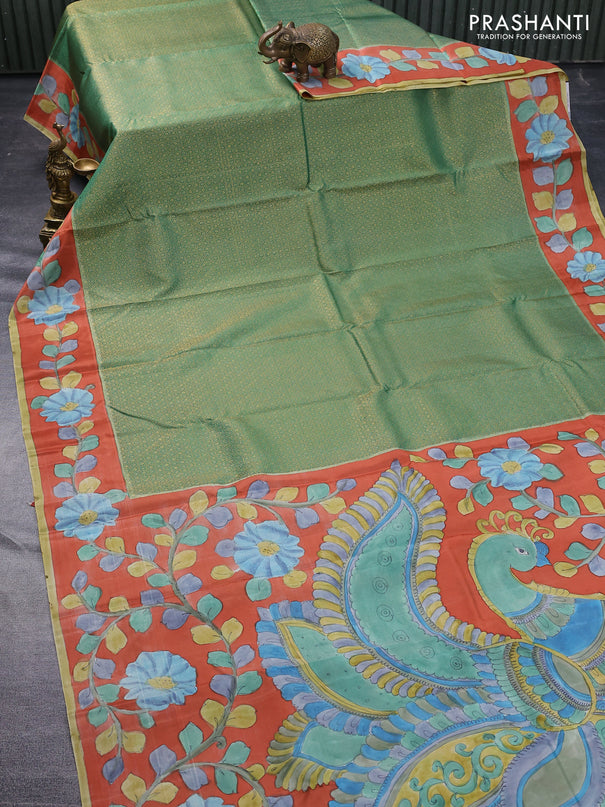 Pure kanchipuram silk saree teal green and rustic orange with allover zari woven geometric brocade weaves and kalamkari printed pallu & border