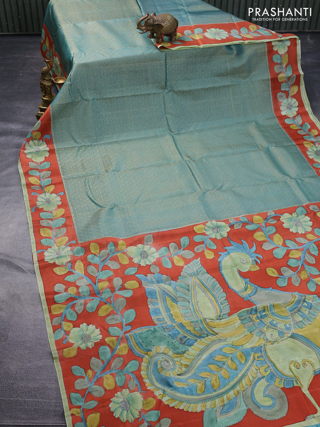 Pure kanchipuram silk saree teal blue and rustic orange with allover zari woven geometric brocade weaves and kalamkari printed pallu & border
