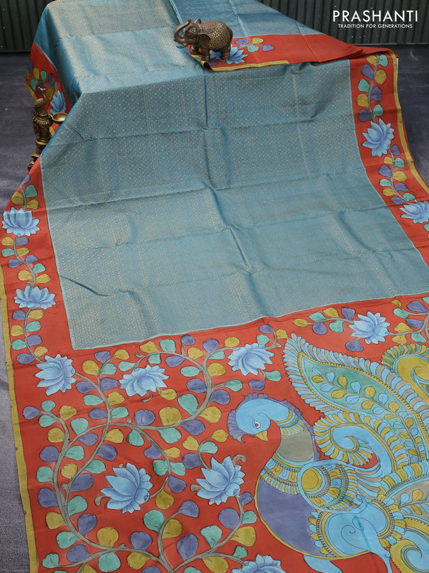 Pure kanchipuram silk saree pastel blue and rustic orange with allover zari woven geometric brocade weaves and kalamkari printed pallu & border