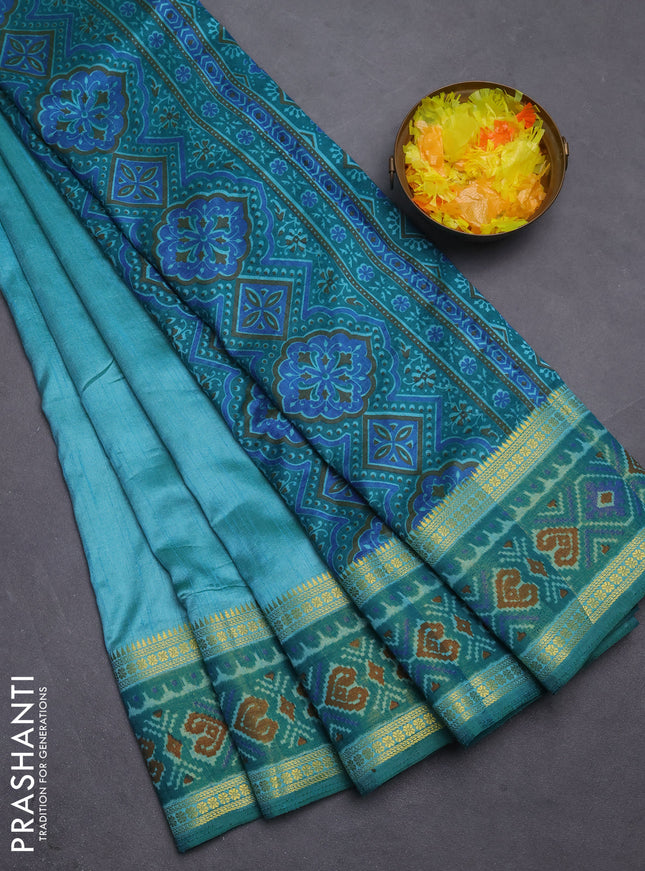Semi tussar saree dual shade of teal blue with plain body and ikat woven zari border