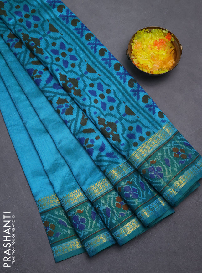 Semi tussar saree dual shade of teal blue and teal green with plain body and ikat woven zari border