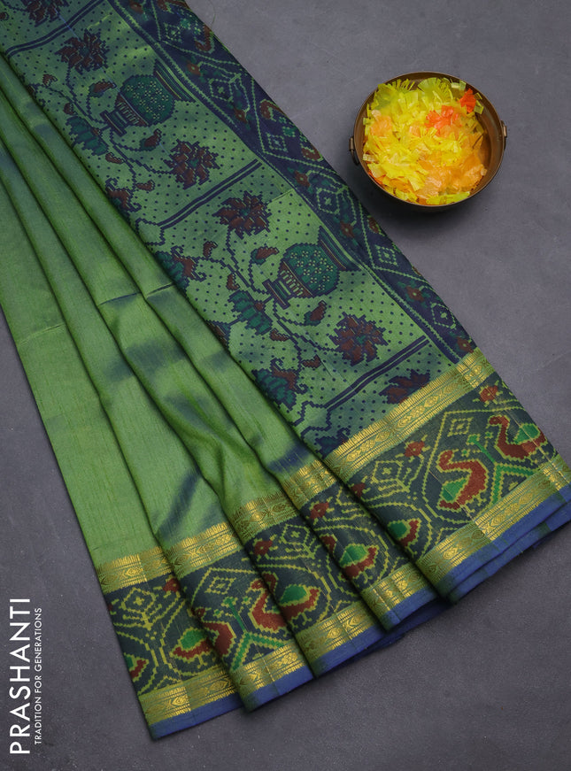 Semi tussar saree dual shade of greenish blue and blue with plain body and ikat woven zari border