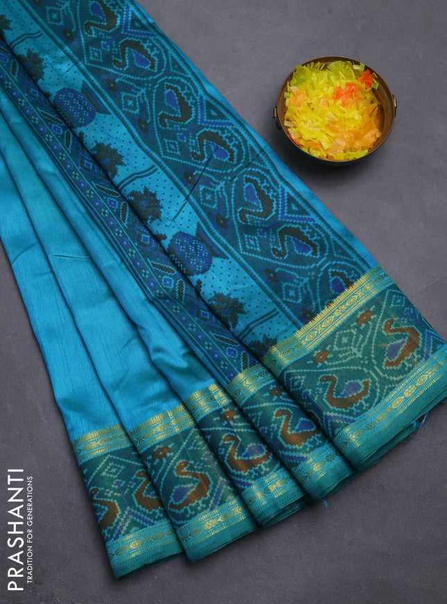 Semi tussar saree dual shade of teal blue and green with plain body and ikat woven zari border