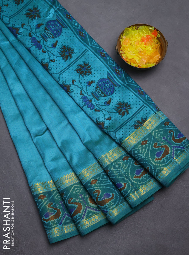 Semi tussar saree dual shade of teal blue and green with plain body and ikat woven zari border