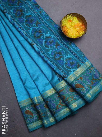 Semi tussar saree dual shade of teal blue and green with plain body and ikat woven zari border