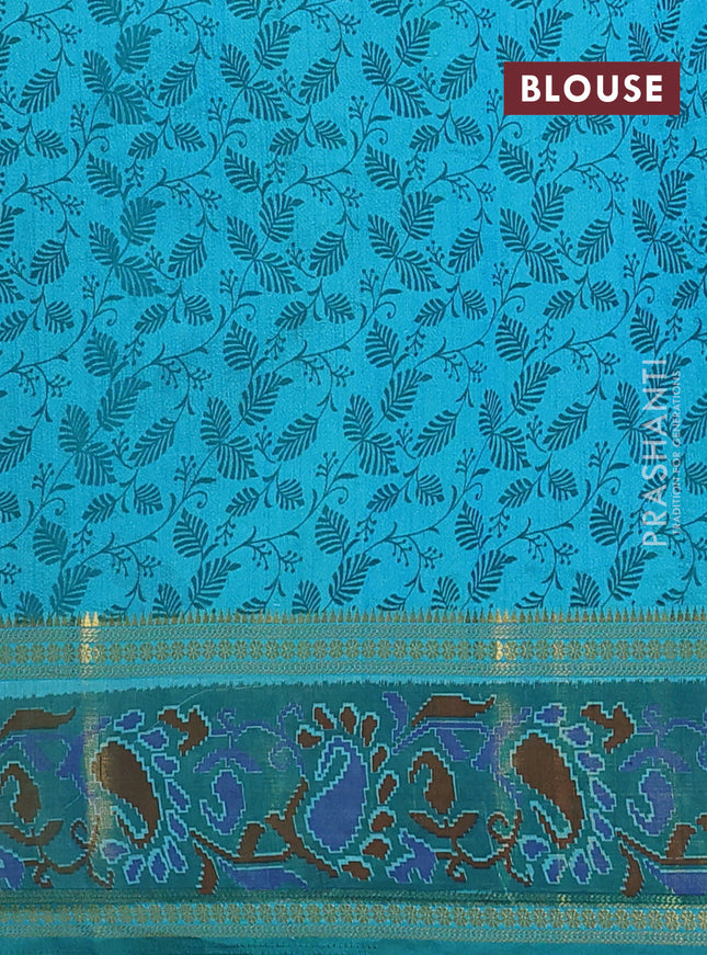 Semi tussar saree dual shade of teal blue and green with plain body and ikat woven zari border