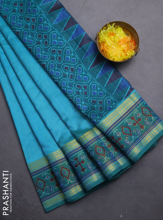 Semi tussar saree dual shade of teal blue and green with plain body and ikat woven zari border