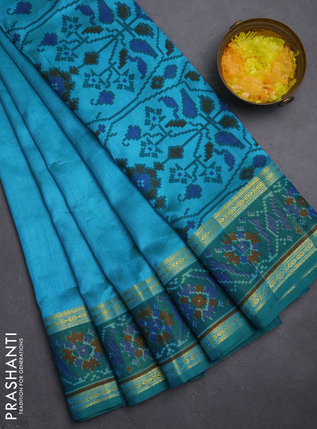Semi tussar saree teal blue and green with plain body and ikat woven zari border