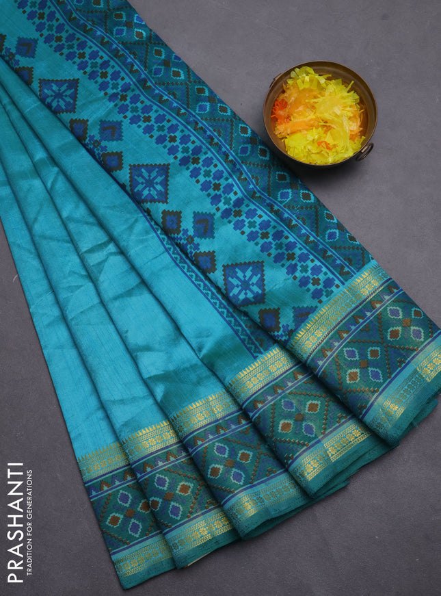 Semi tussar saree dual shade of teal blue and green with plain body and ikat woven zari border