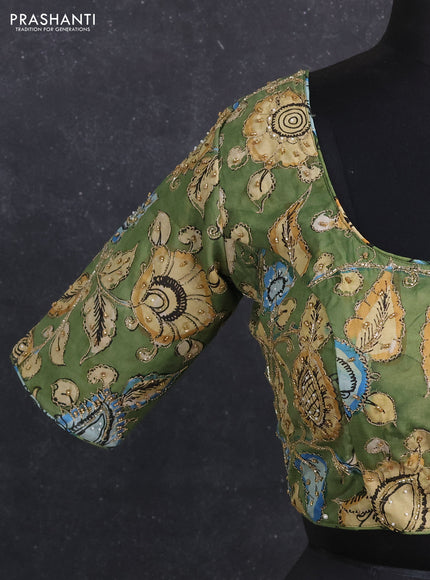Silk penkalamkari readymade blouse green with allover kalamkari prints & pita work and back knot