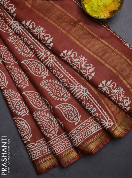 Semi bhagalpuri saree rust with allover prints and zari woven border