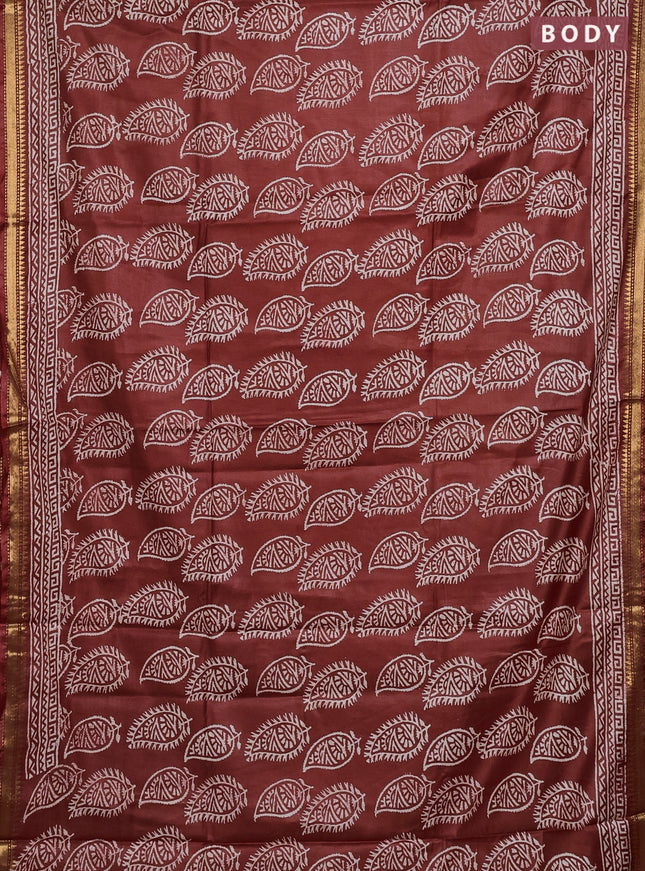 Semi bhagalpuri saree rust with allover prints and zari woven border