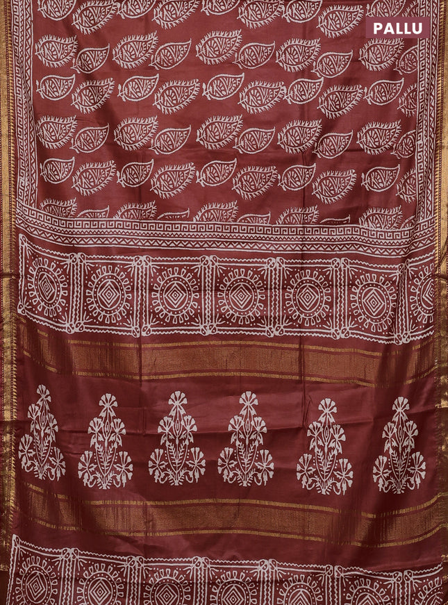 Semi bhagalpuri saree rust with allover prints and zari woven border