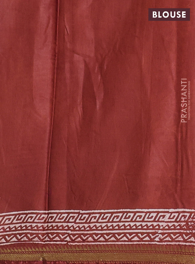 Semi bhagalpuri saree rust with allover prints and zari woven border