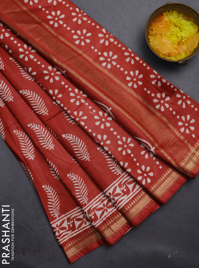 Semi bhagalpuri saree rust with allover prints and zari woven border