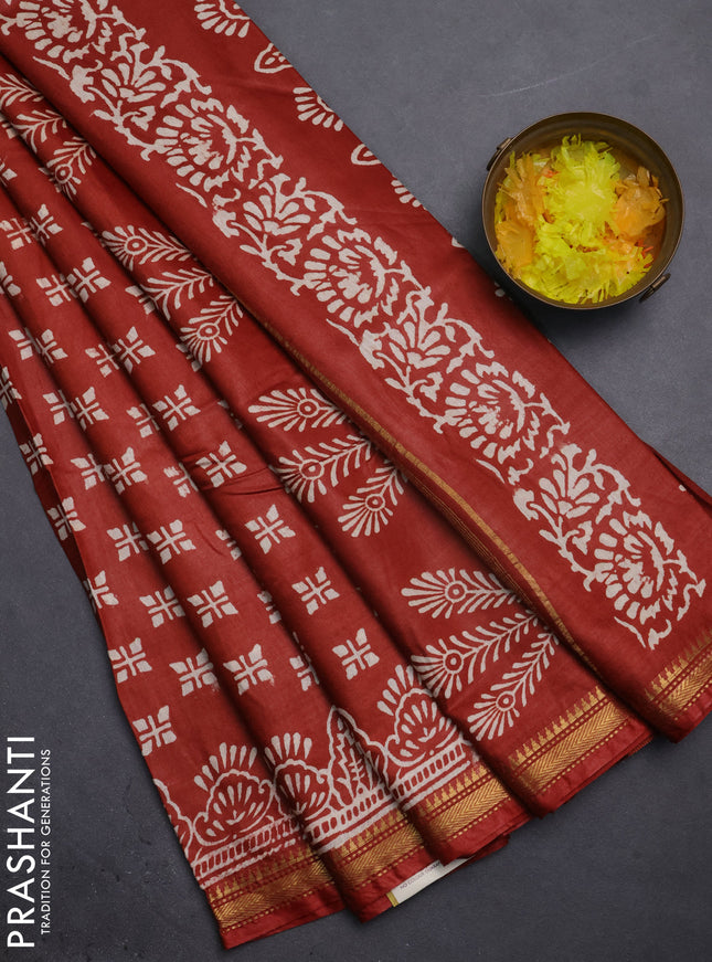 Semi bhagalpuri saree rust with allover prints and zari woven border