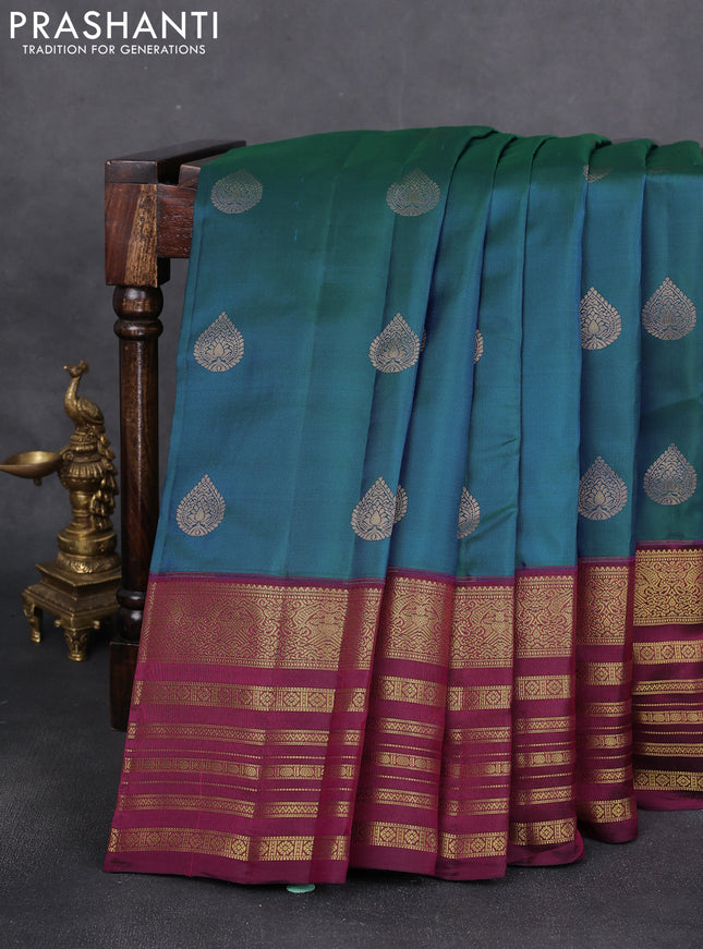 Pure kanchipuram silk saree dual shade of bluish green and dark magenta pink with zari woven buttas and long zari woven border