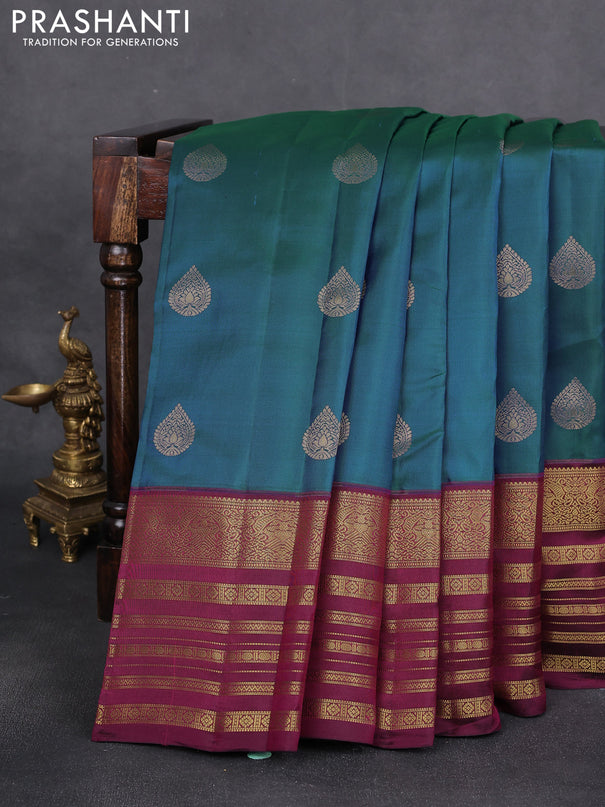Pure kanchipuram silk saree dual shade of bluish green and dark magenta pink with zari woven buttas and long zari woven border