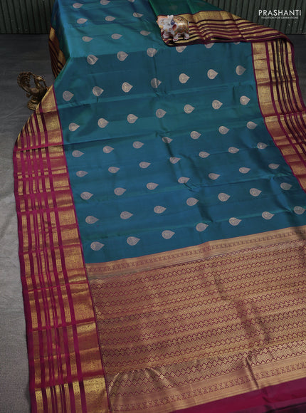 Pure kanchipuram silk saree dual shade of bluish green and dark magenta pink with zari woven buttas and long zari woven border
