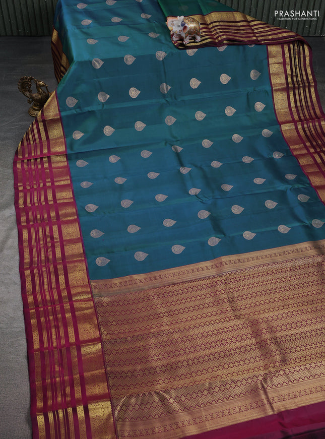 Pure kanchipuram silk saree dual shade of bluish green and dark magenta pink with zari woven buttas and long zari woven border