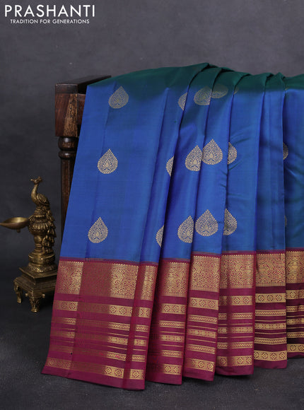 Pure kanchipuram silk saree dual shade of bluish green and dark magenta pink with zari woven buttas and long zari woven border